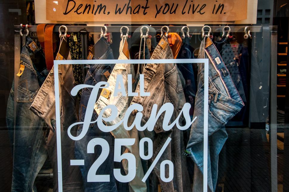 Free Image of Sale sign on the clothes shop window. 