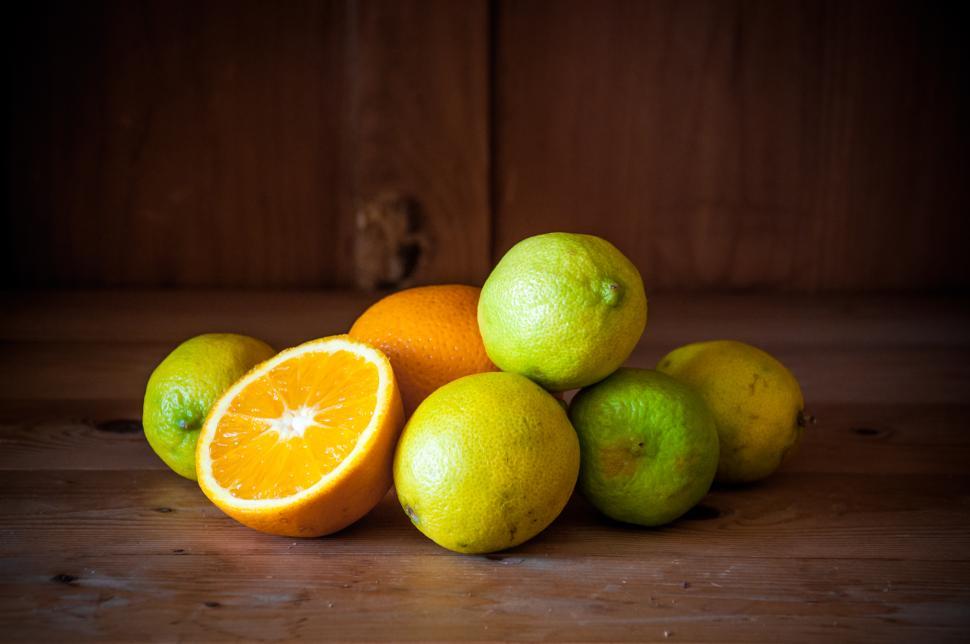 Free Image of Citrus fruits. Oranges, limes and lemons on wood 