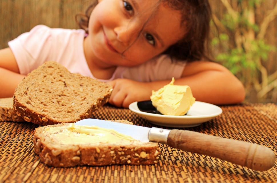 Free Image of Child preparing to eat bread & butter 