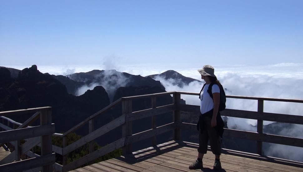 Free Image of Woman looking out on the mountain summit 