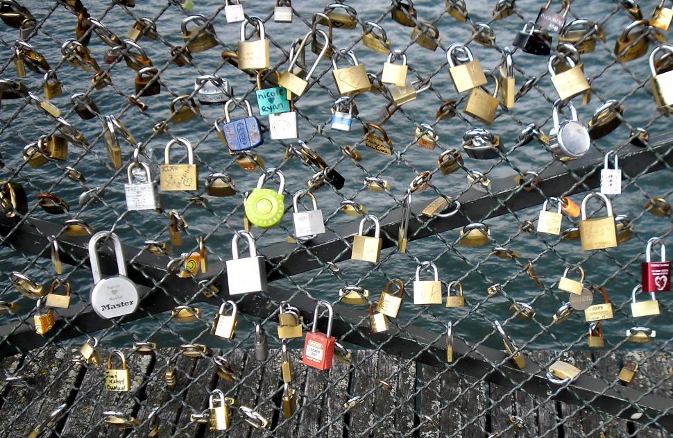 Free Image of Love locks placed by tourists on the Pont des Arts on the river  