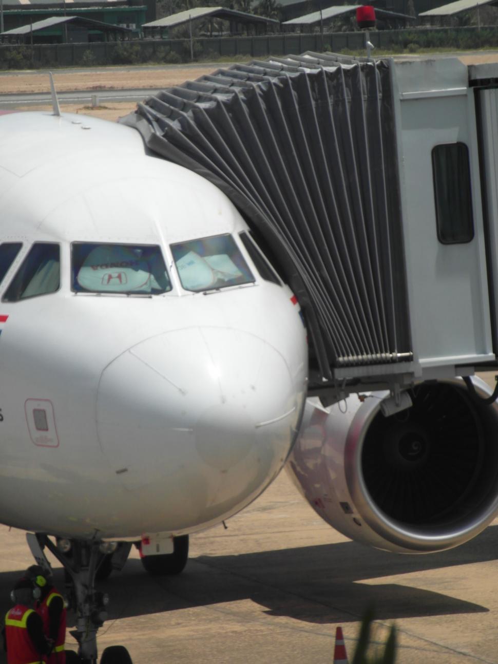 Free Image of Airplane Connected to Walkway 