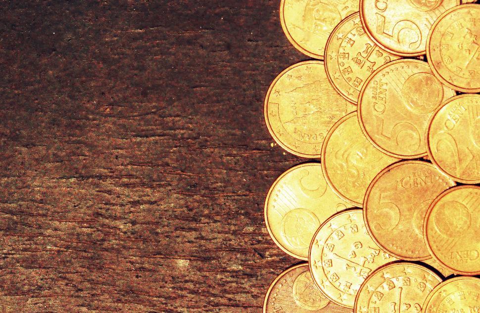 Free Image of Euro coins on old wooden background 