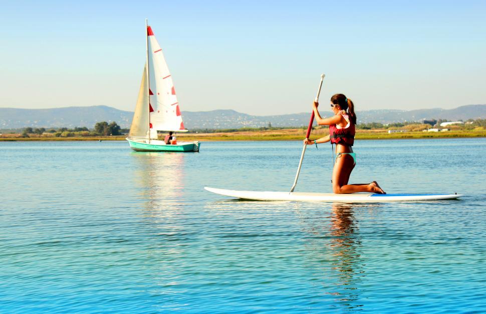 Free Image of Woman practicing stand-up paddle 