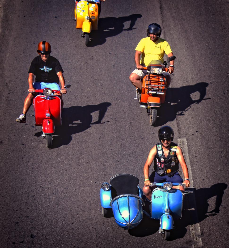 Free Image of  Colorful group of bikers riding vintage italian scooters. Edito 