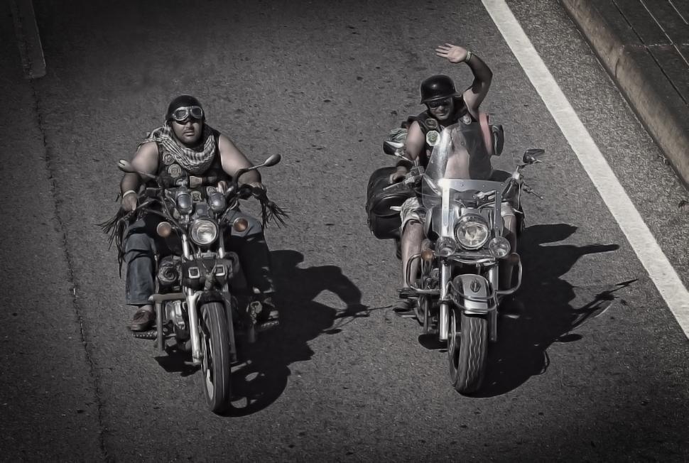 Free Image of Biker waving on a Harley Davidson. Editorial use only. 