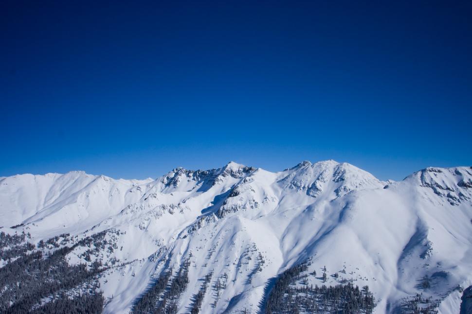 Free Image of Snow Covered Mountain Range Under Blue Sky 