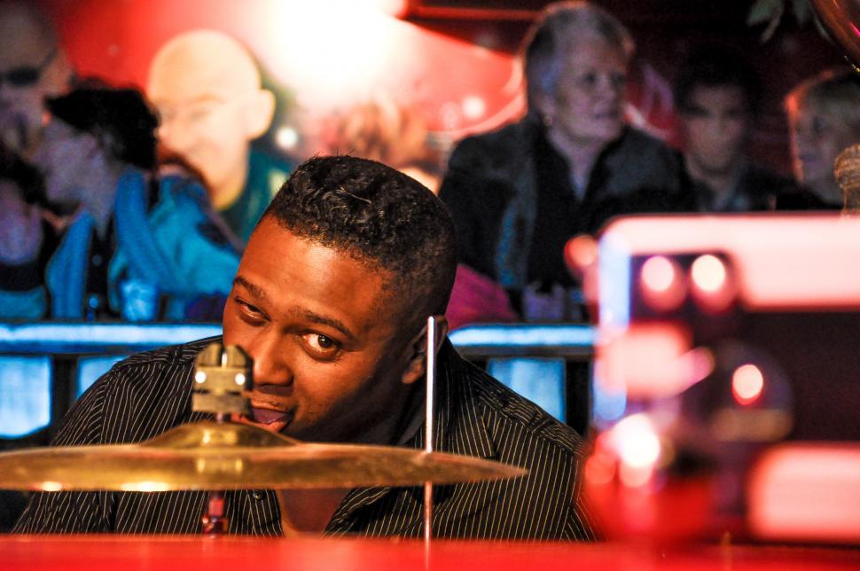 Free Image of Man Playing Drums in Front of Crowd 