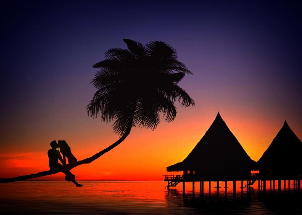 Free Image of Romantic couple kissing in love at sunset in a tropical island - 
