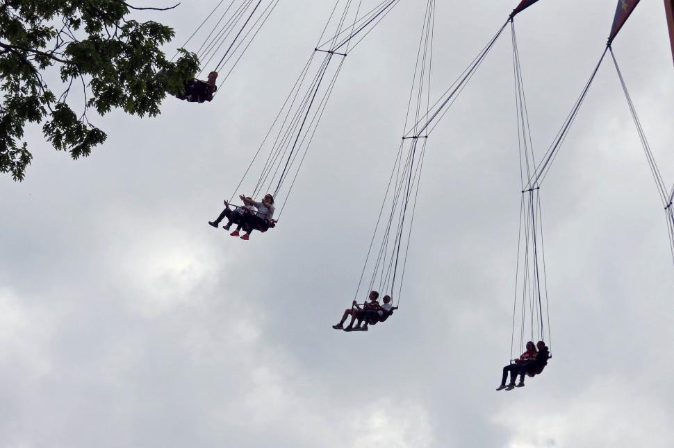 Free Image of People riding on swing ride at fair 