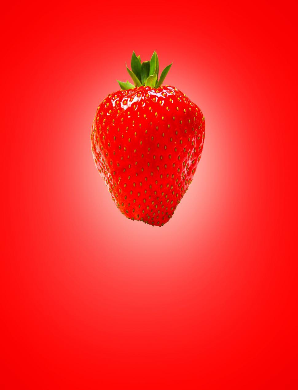 Free Image of Red Strawberry on Red Background 