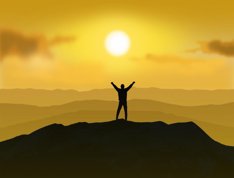 Free Image of Victorious - Man standing on the top of a mountain raising  