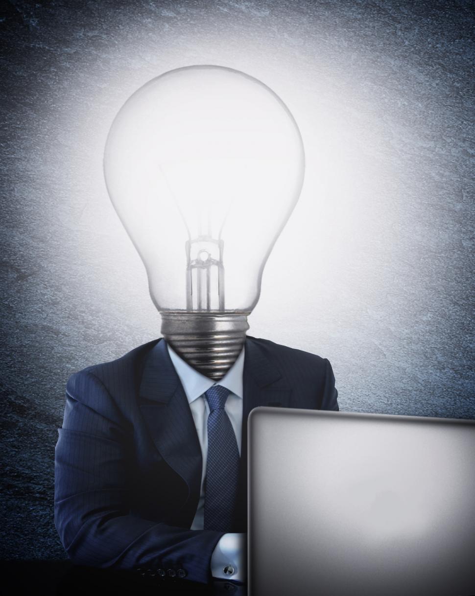 Free Image of Businessman with lightbulb head in front of the computer 