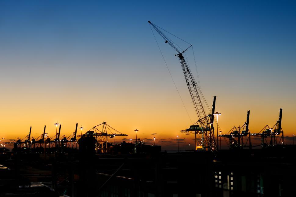 Free Image of Construction cranes at sunset 