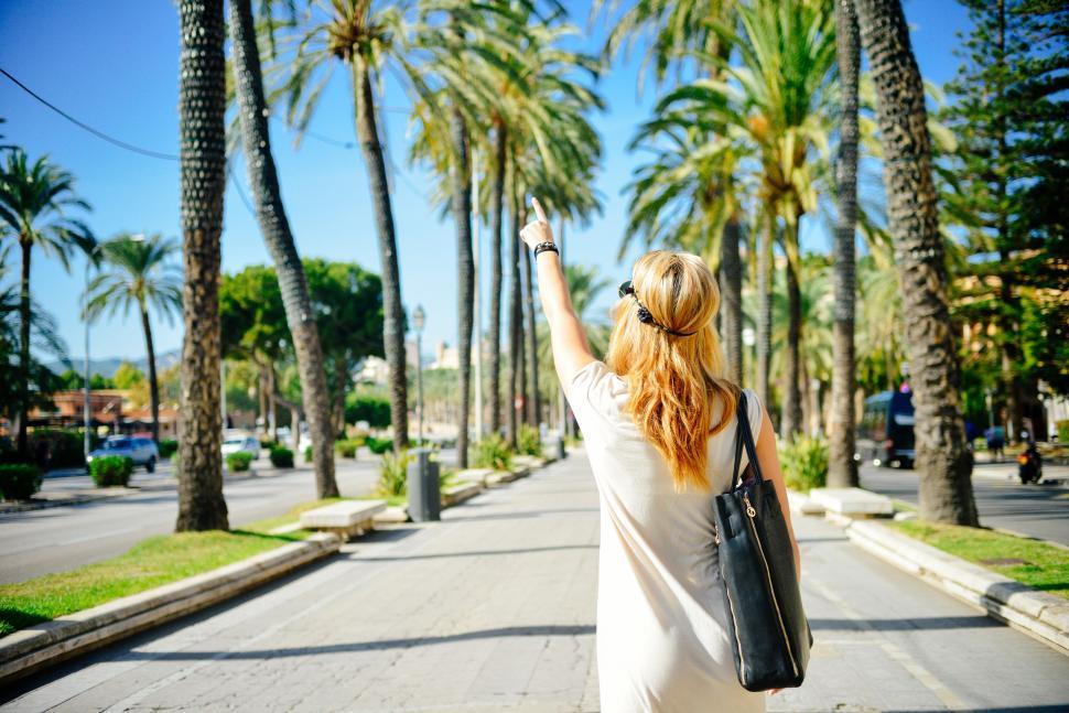 Free Image of Rear view of a woman pointing finger 