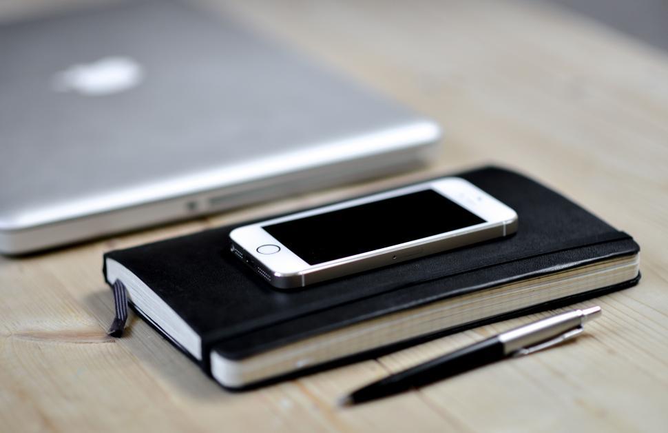 Free Image of Mobile phone on a notebook 