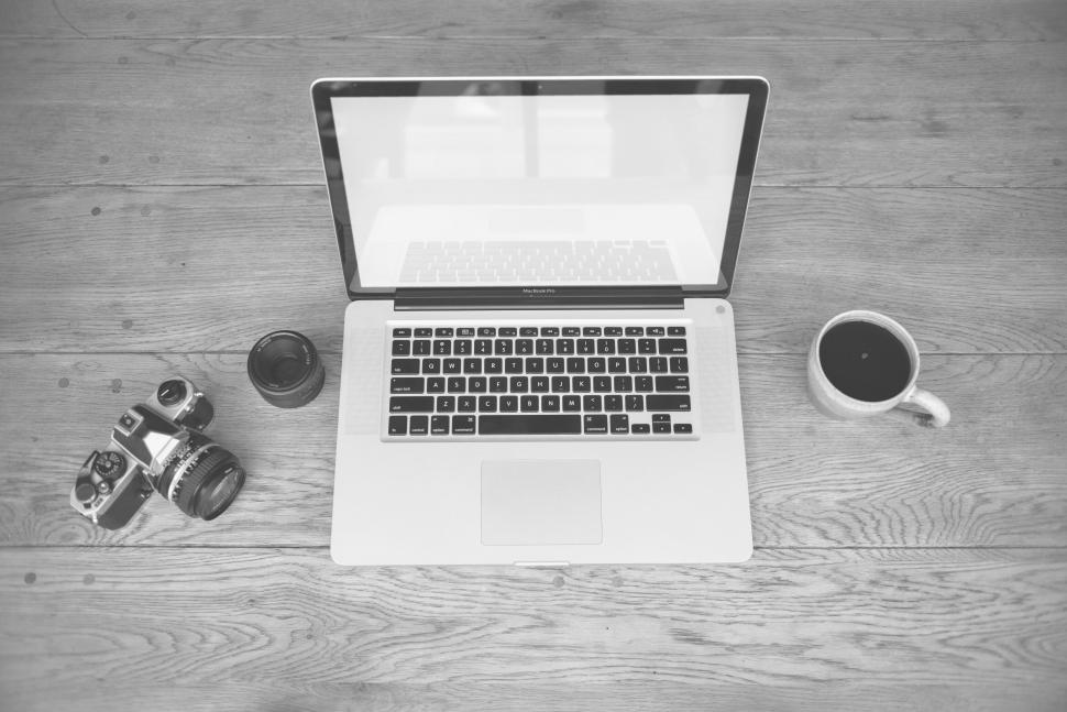 Free Image of SLR camera and open laptop 