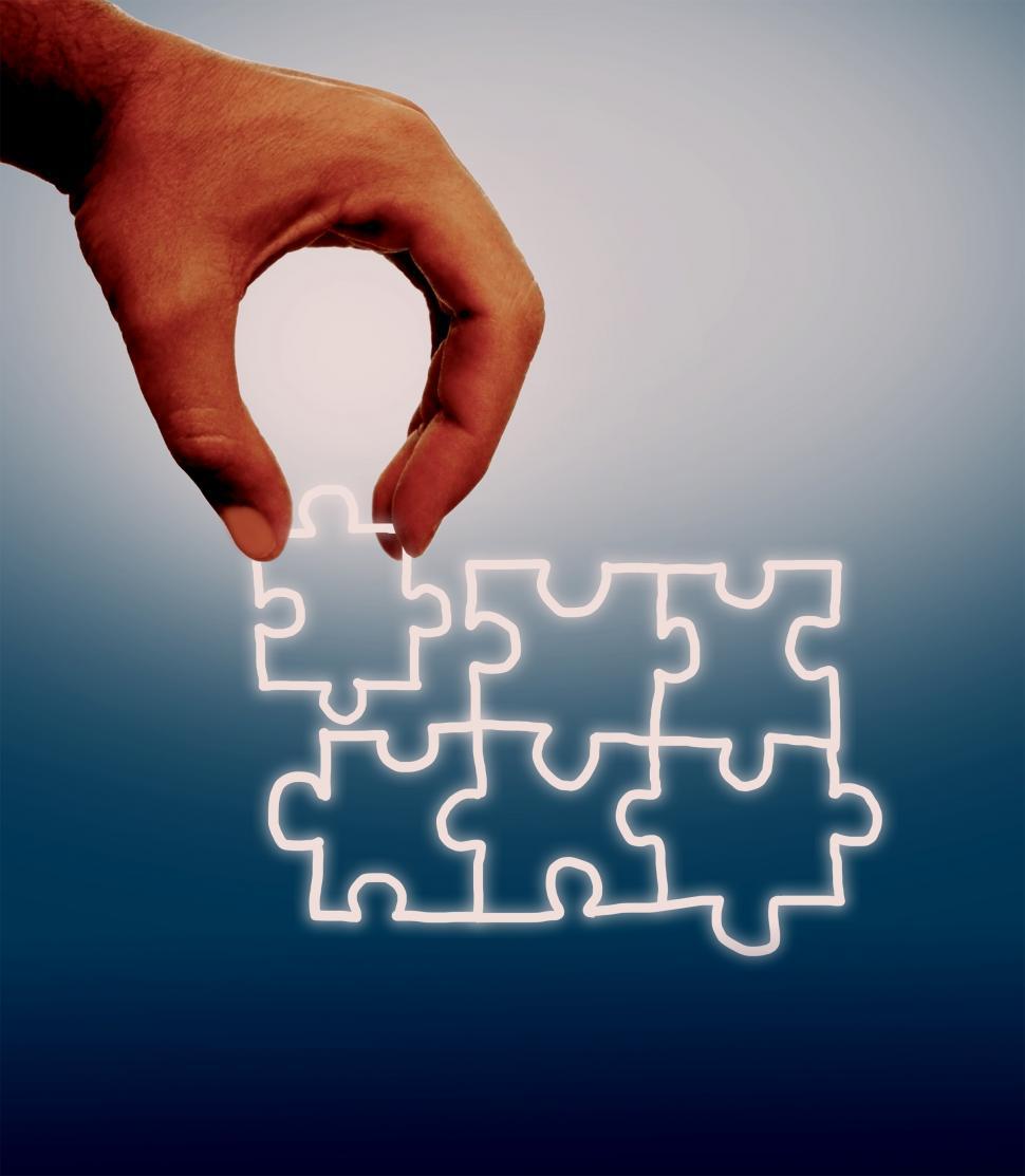 Free Image of Hand assembling jigsaw on virtual screen 