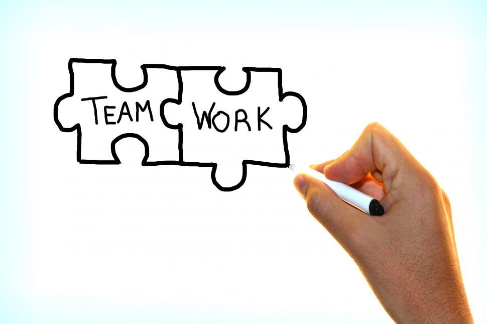 Free Image of Hand writing the words Team Work on virtual screen 