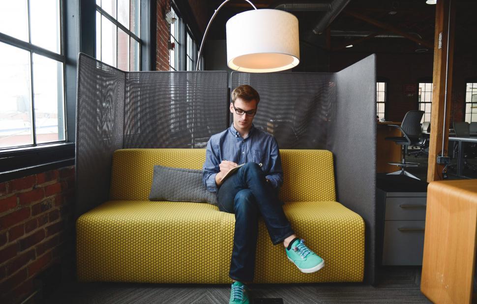 Free Image of Taking notes on the couch 