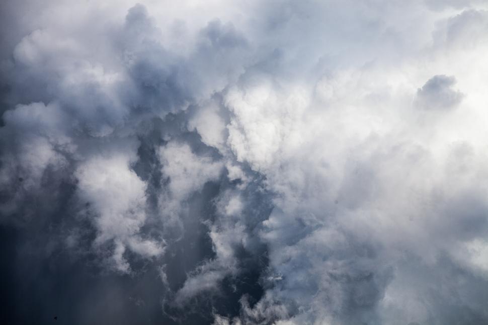 Free Image of Plane Flying Through Cloudy Sky 