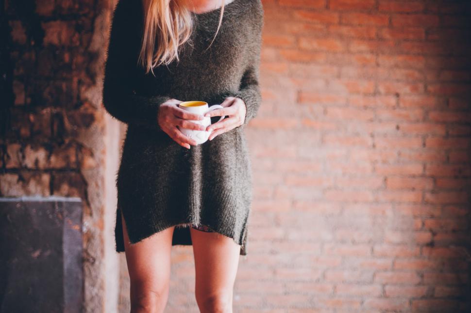 Free Image of Woman holding a coffee mug 