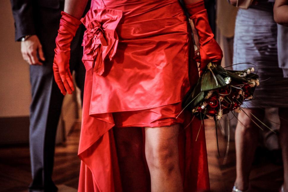 Free Image of A woman in red with flowers 