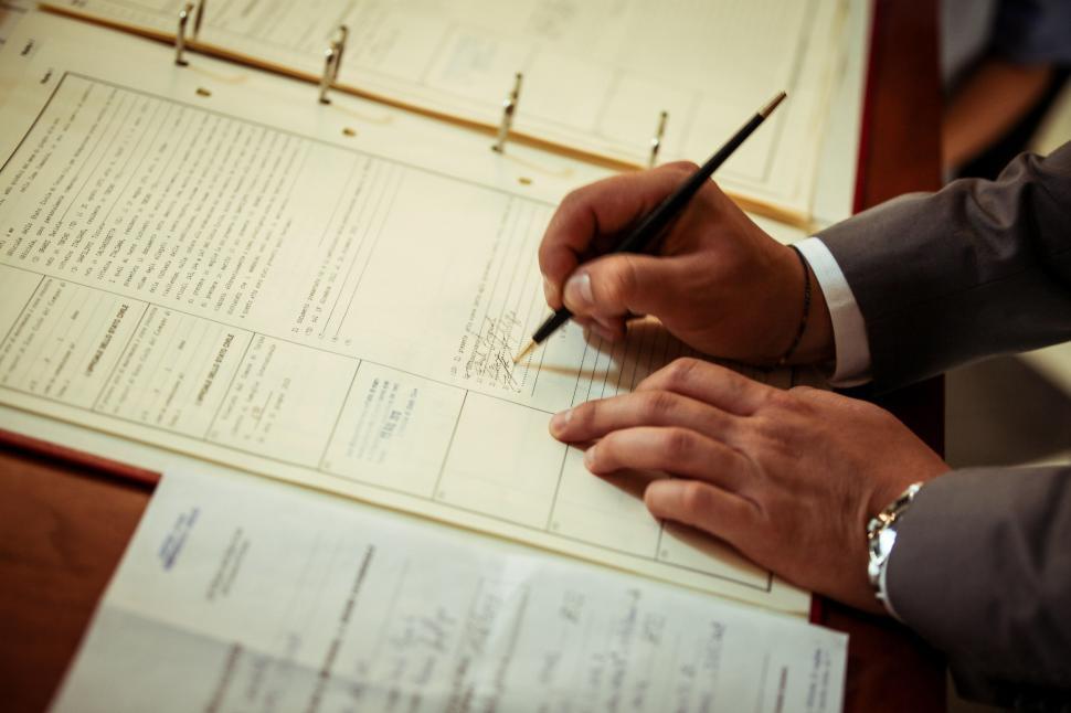 Free Image of Groom signing marriage certificate 