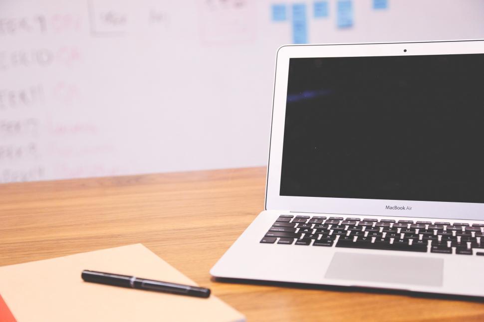 Free Image of Laptop open with notebook 