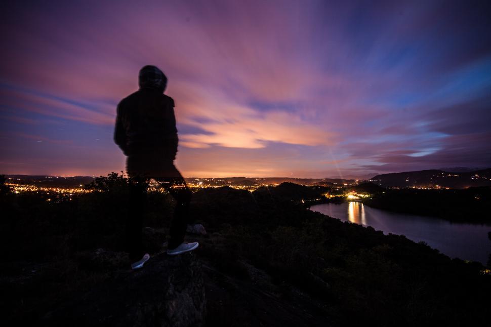 Free Image of Person standing and looking at the sunset 