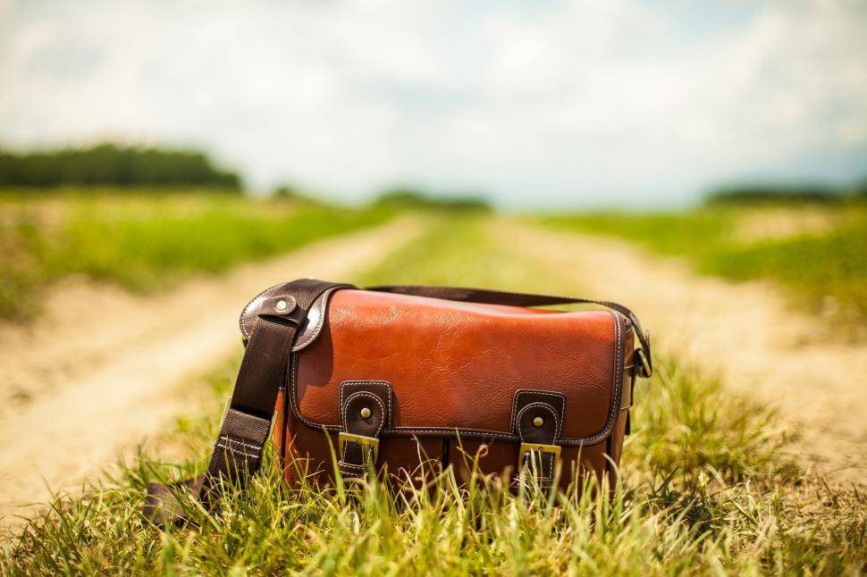 Free Image of Close view of shoulder bag on the ground 