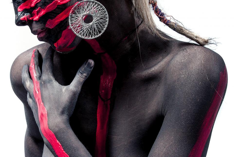 Free Image of Woman with black and red paint on her body 