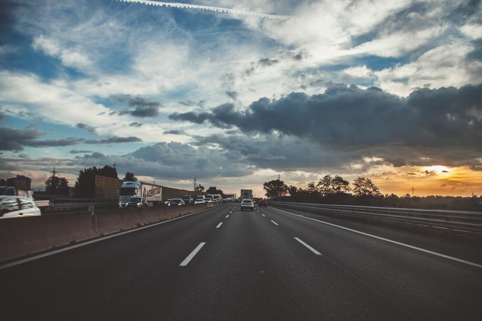 Free Image of White and grey clouds over highway 