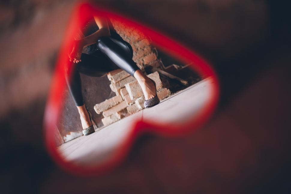 Free Image of A woman s legs seen through a mirror 
