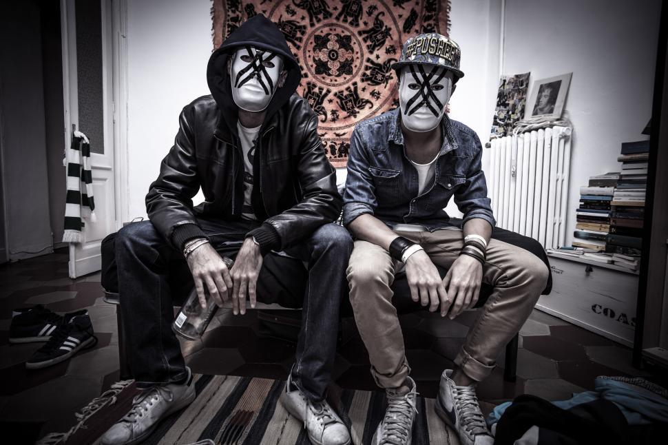 Free Image of Two People With Painted Faces Sitting on a Bench 
