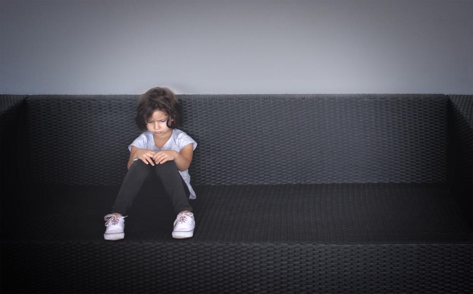 Free Image of Sulky young kid on the couch 