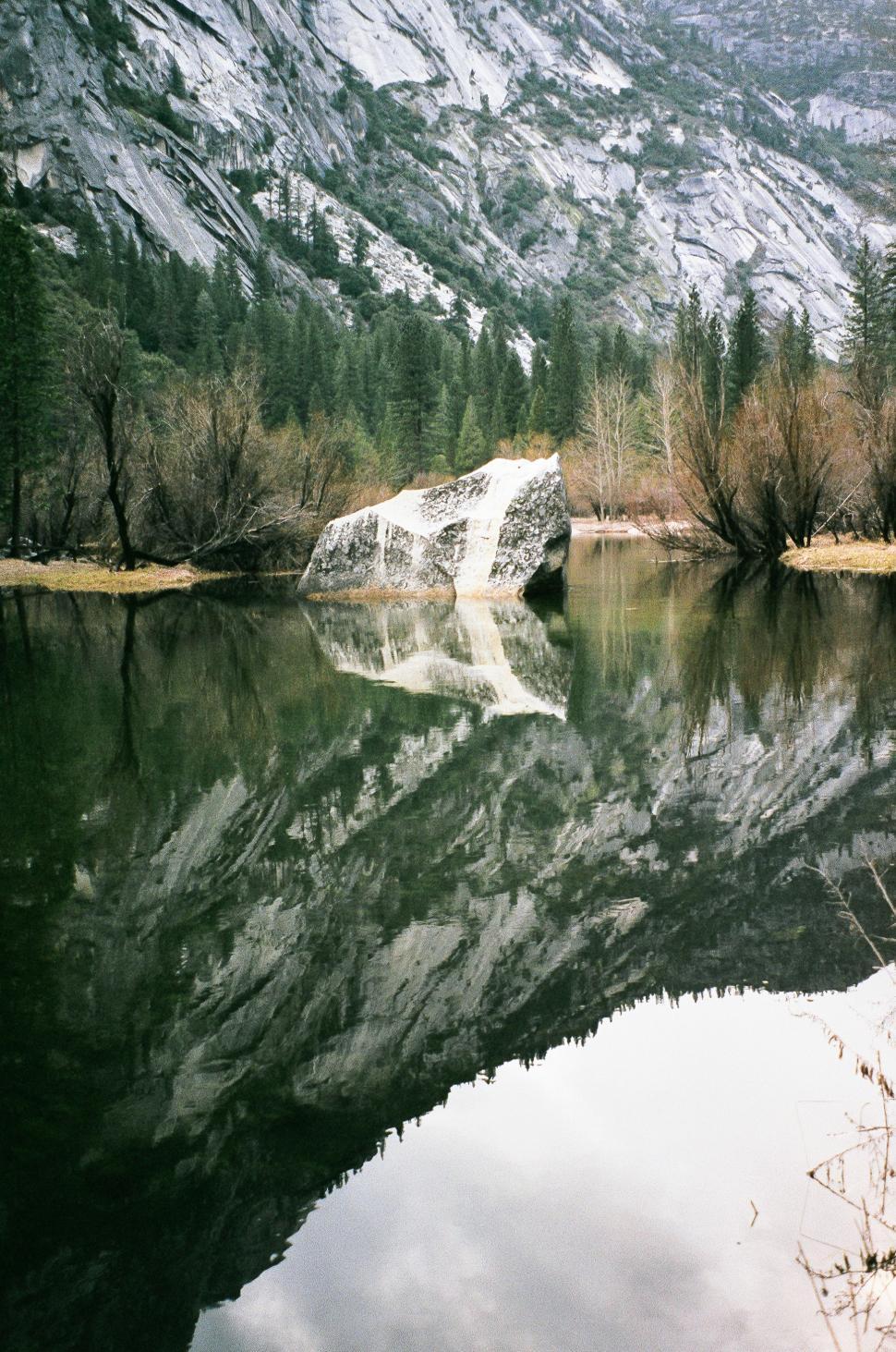 Free Image of Large Rock in the Middle of a Lake 