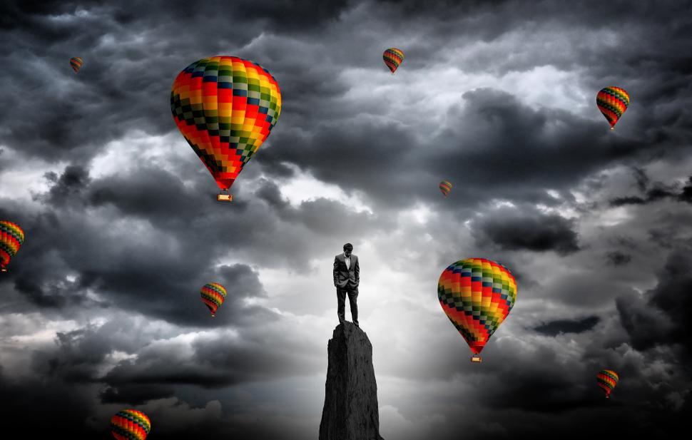 Free Image of Businessman on the summit surrounded by hot air balloons - Ambit 