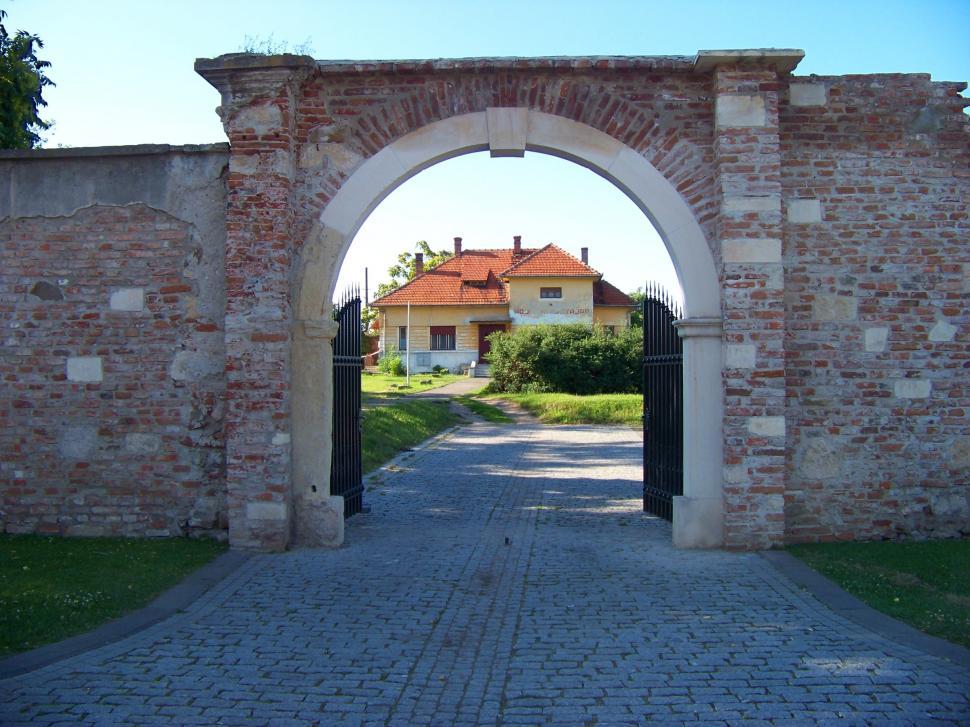 Free Image of House seen through a brick gate  