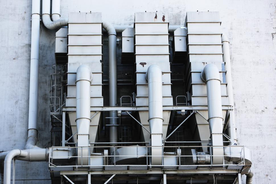 Free Image of Group of Pipes Attached to Side of Building 
