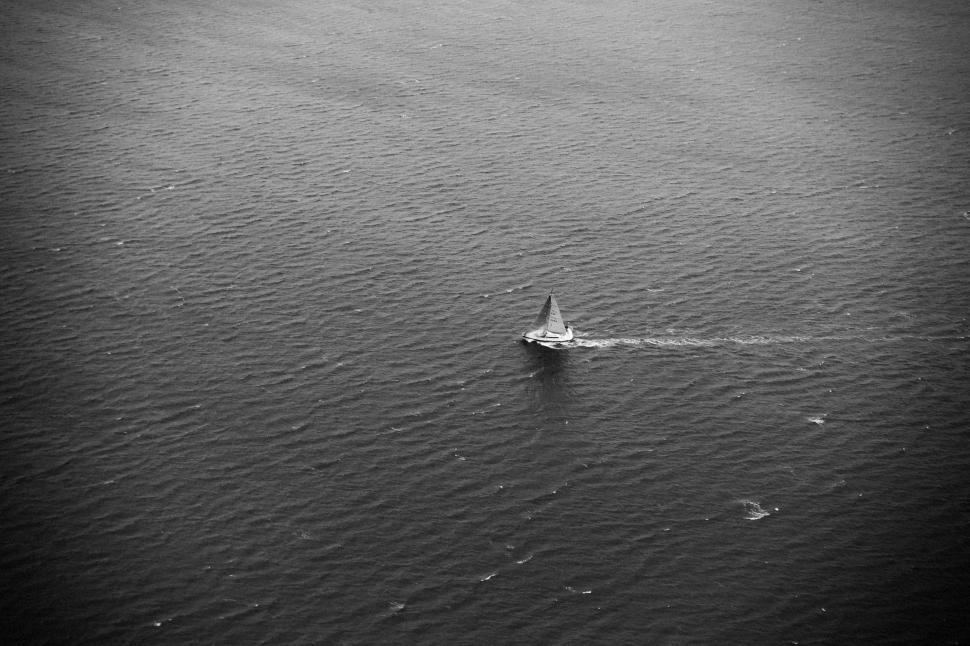 Free Image of Small Plane Flying Over Large Body of Water 