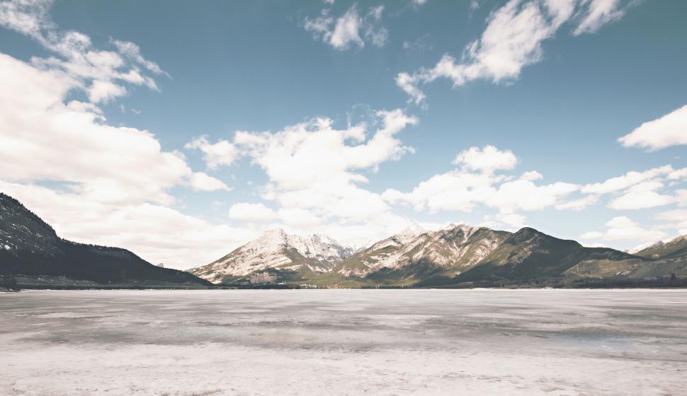Free Image of Snow Covered Field With Mountains in Background 
