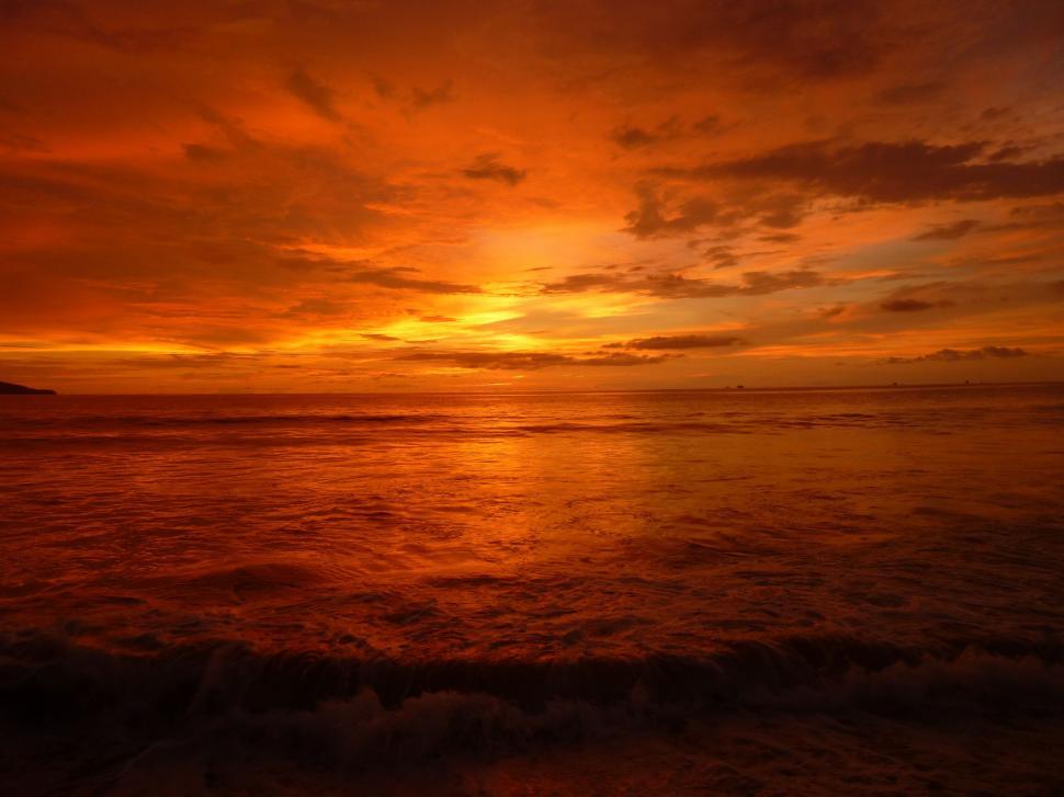 Free Image of Sunset Over the Ocean With Clouds in the Sky 
