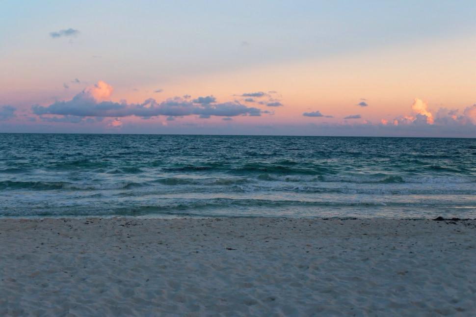 Free Image of Person Walking on Beach With Surfboard 