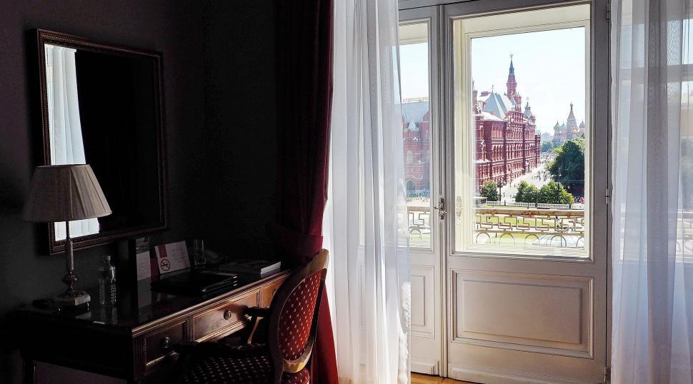 Free Image of Room With Door and Window Overlooking City 