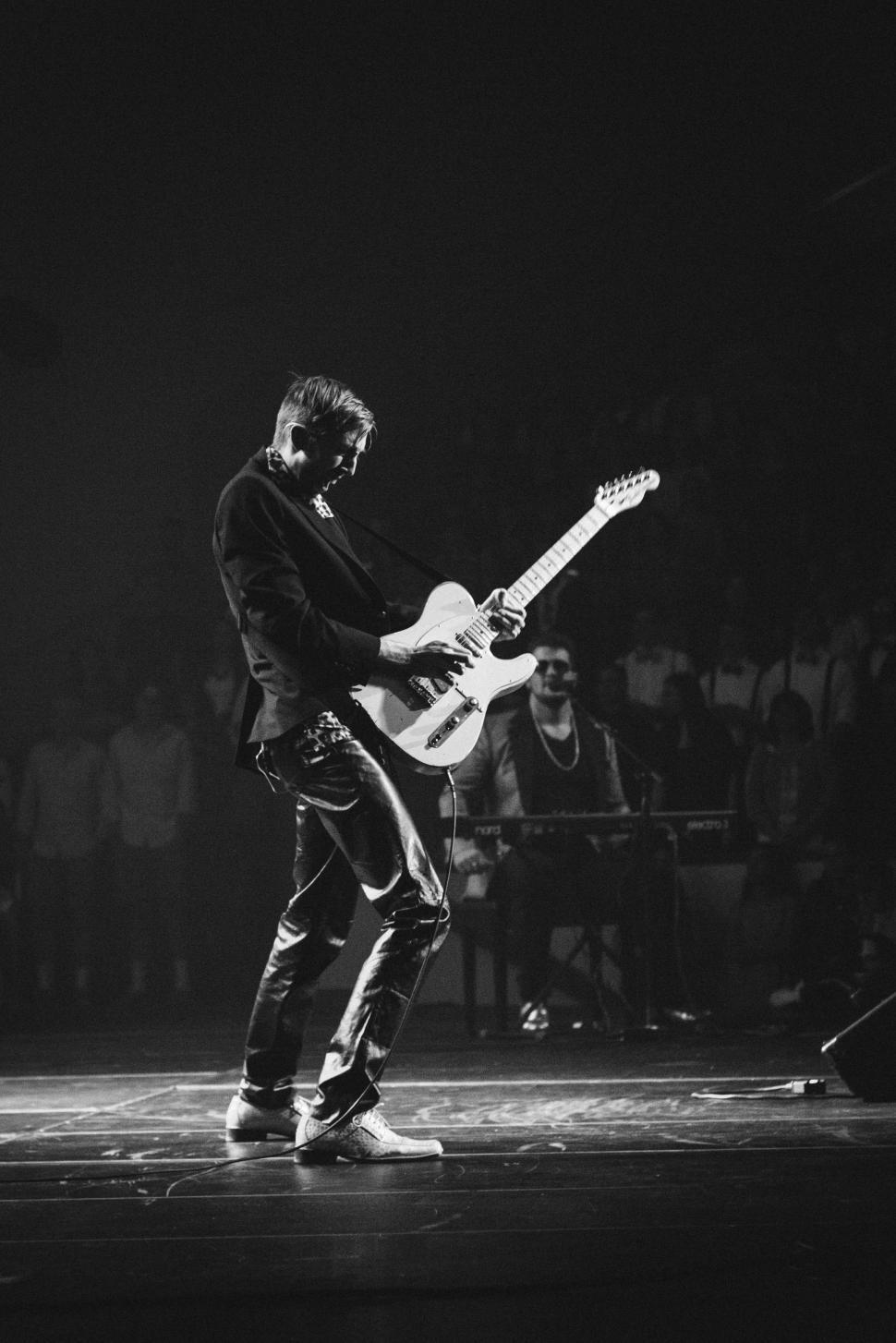 Free Image of Man Playing Guitar in Black and White 