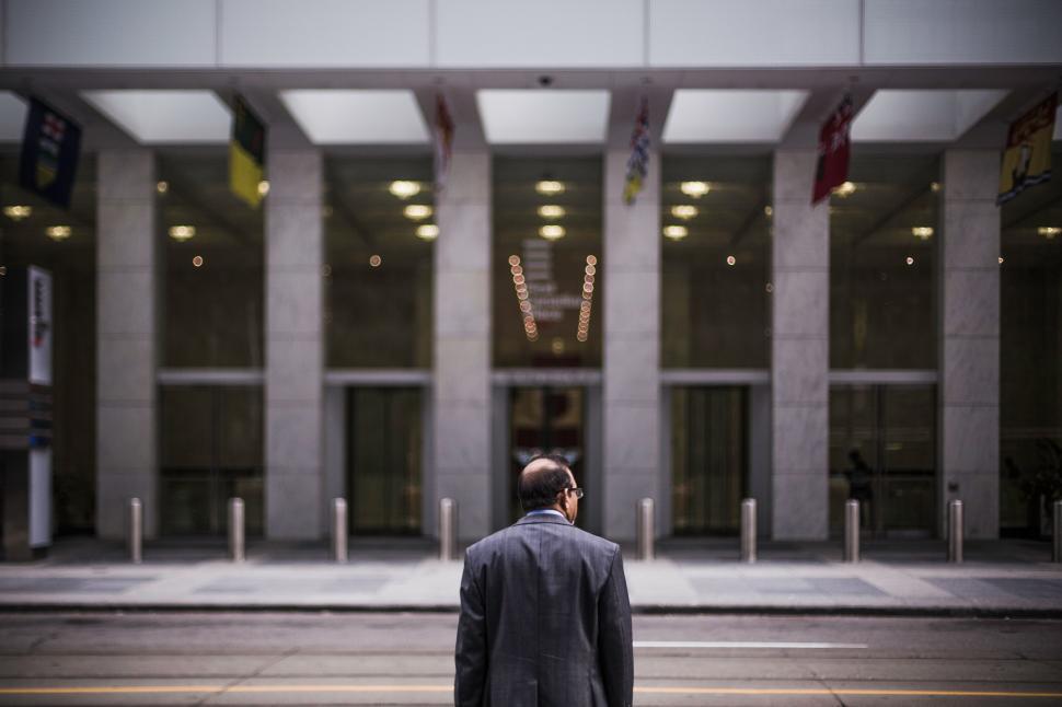 Free Image of Man Standing in Front of Large Building 