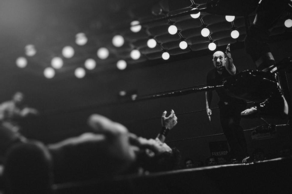 Free Image of Man Standing on Top of a Stage Holding a Microphone 