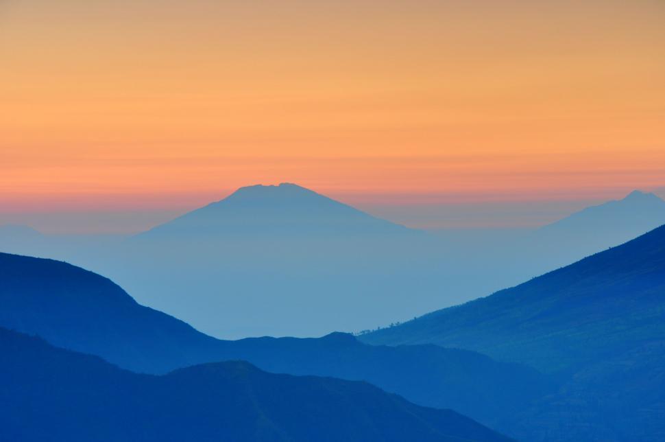 Free Image of Majestic Mountain Range Silhouetted by Sunset 