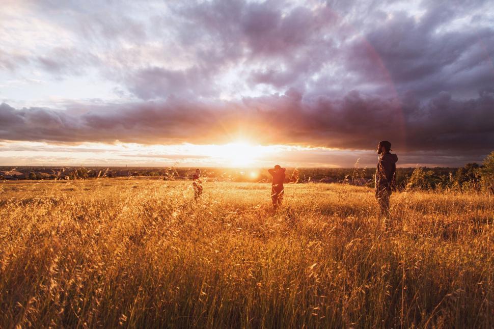 Free Image of Two People Standing on Top of Grass Covered Field 